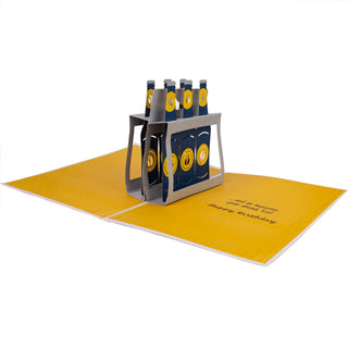 Fully open beer birthday pop-up card with the six-pack of beer bottles and printed greeting.