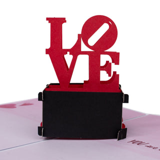 Close-up of the iconic red LOVE statue details in the lOVE statue Valentine's Day pop-up card